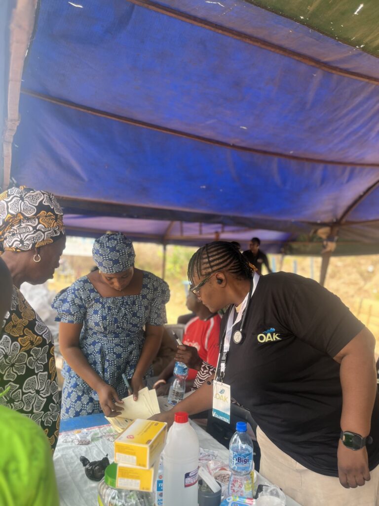 OAKonsult volunteers and health workers around a medical supplies table during the outreach